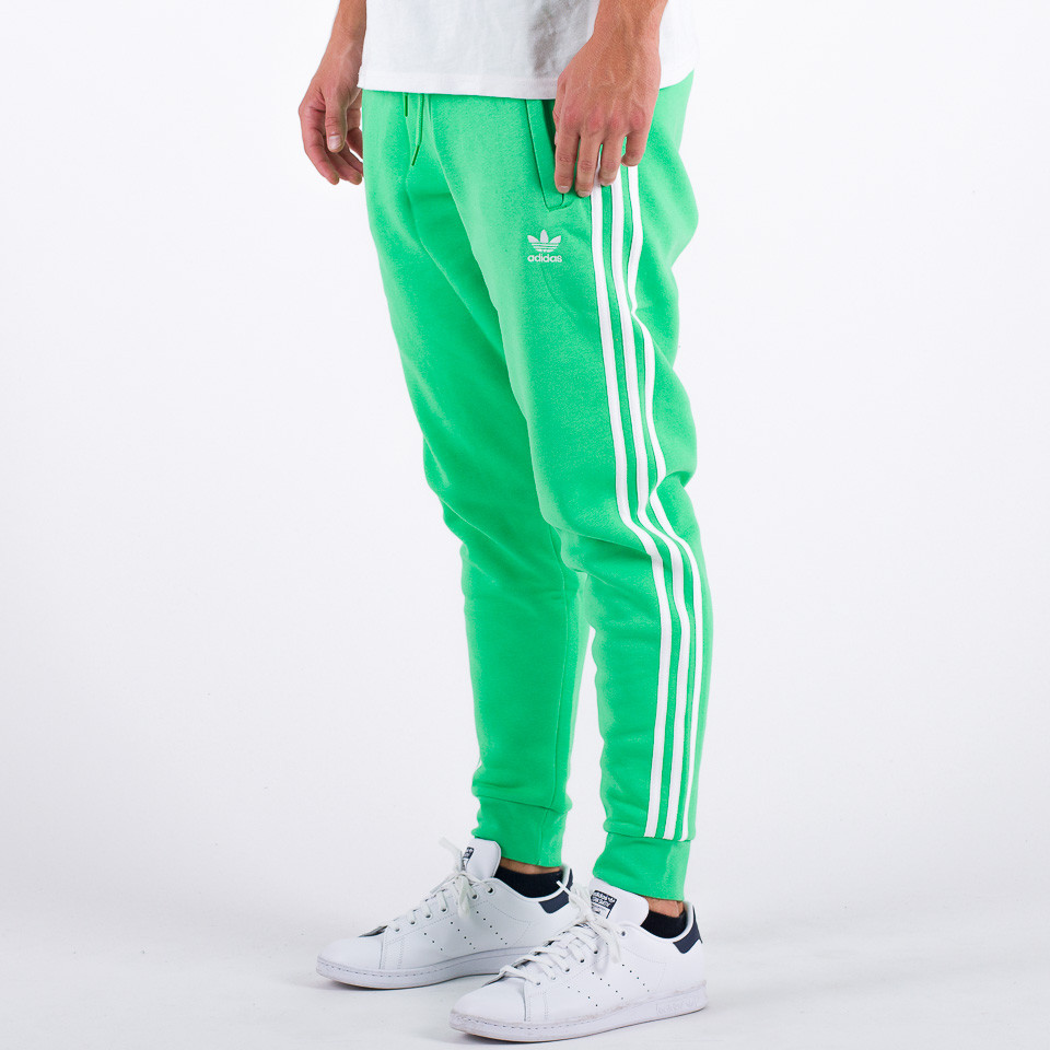 Adidas pants shop with green stripes